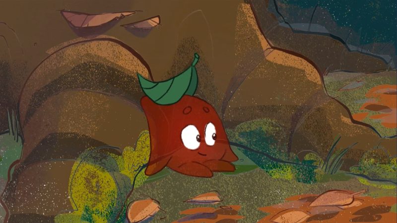 Animação mostra uma folha marrom com olhos e expressão curiosa, deitada no chão com uma pequena folha verde na cabeça, em meio a pedras, galhos e vegetação rasteira.