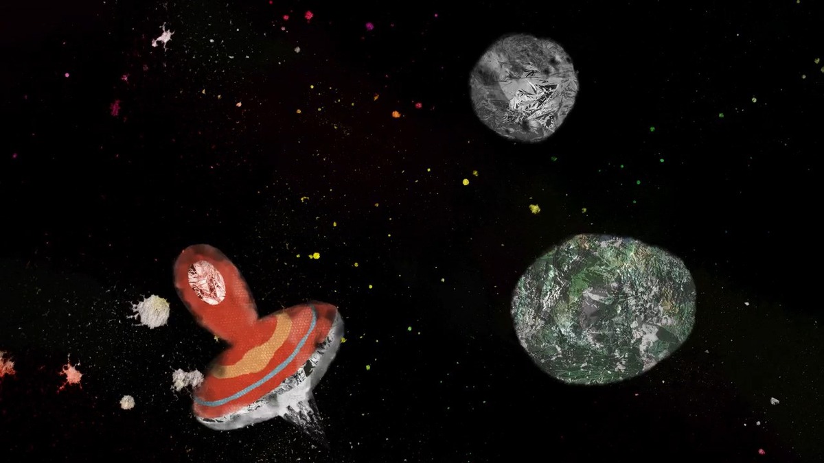 Animação mostra um pião vermelho girando pelo espaço entre pequenos asteroides e planetas.
